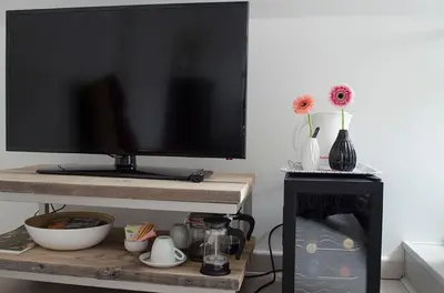 a flat screen tv sitting on top of a tv stand at upstairs9000 in Ghent