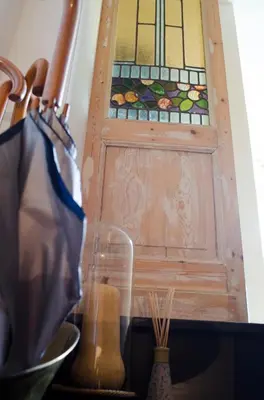a wooden door with a stained glass window on it at upstairs9000 in Ghent