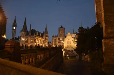 a view of a city at night with a clock tower at Guesthouse PPP in Ghent