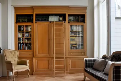 a large wooden book case in a living room at Guesthouse PPP in Ghent