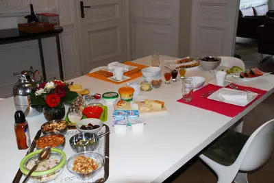 a white table with food on top of it at Guesthouse PPP in Ghent