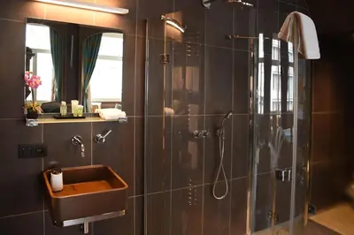 a bathroom with a sink and a shower at Guesthouse PPP in Ghent