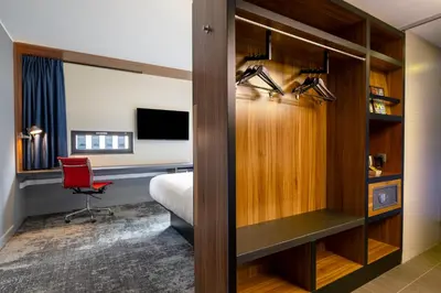 a hotel room with a bed and a desk at Pestana Brussels Schuman in Brussels