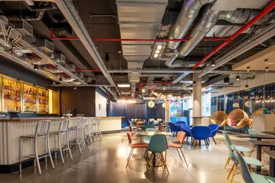 a restaurant with chairs and tables and a bar at Pestana Brussels Schuman in Brussels