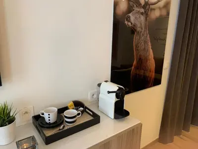 a table with a coffee maker and cups on it at Q Studio in Herzele