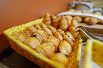 a basket filled with pastries on a table at Hotel Otus in Wetteren