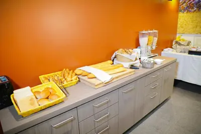 a buffet with bread and cheese on a table at Hotel Otus in Wetteren