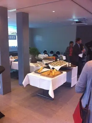 a restaurant with two tables with food on them at Hotel Otus in Wetteren