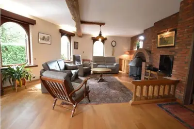 a living room with a couch and a fireplace at Lovely Holiday Home in Merksplas with Fenced Garden in Merksplas
