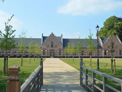a walkway in front of a large building at Lovely Holiday Home in Merksplas with Fenced Garden in Merksplas