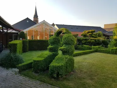 a hedge sculpture of a rabbit in a garden at Lovely Holiday Home in Merksplas with Fenced Garden in Merksplas