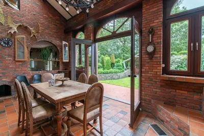 a dining room with a wooden table and chairs at Lovely Holiday Home in Merksplas with Fenced Garden in Merksplas