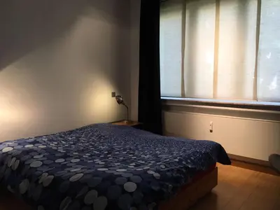 a bedroom with a bed in front of a window at Gachard in Brussels