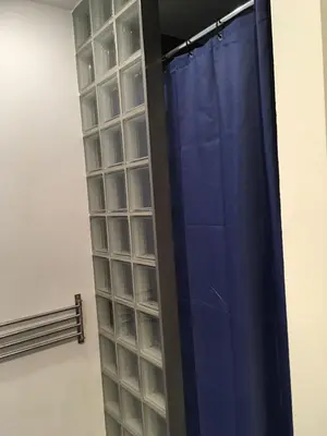 a curtain in a room with a wall of glass at Gachard in Brussels