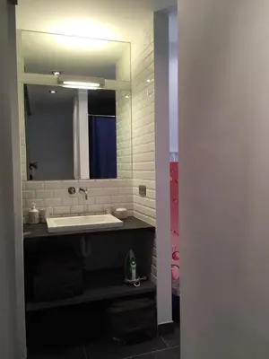 a bathroom with a sink and a mirror at Gachard in Brussels