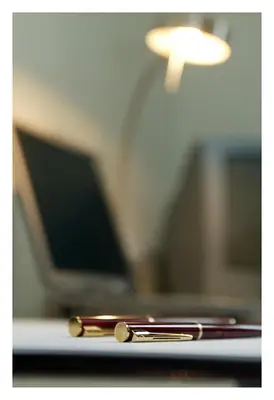 two gold chopsticks sitting on a table next to a lamp at Hotel Florent in Lier