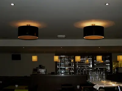two lights hanging from the ceiling of a restaurant at Hotel Florent in Lier