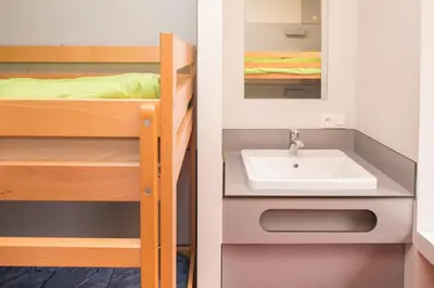 a bathroom with a sink and a bunk bed at Hostel Bruegel in Brussels
