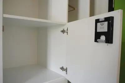 a bathroom with a white cabinet with a soap dispenser at Hostel Bruegel in Brussels