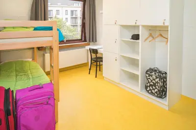 a bedroom with a bunk bed and a desk at Hostel Bruegel in Brussels