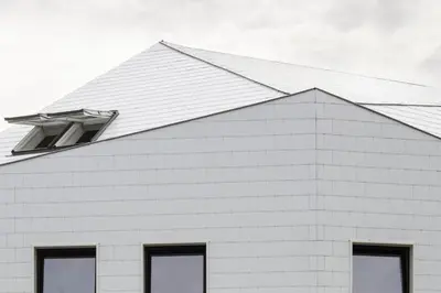 a white building with a window on the side of it at TRUST Hotel in Beveren