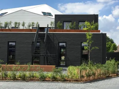 a black house with a black brick facade at TRUST Hotel in Beveren