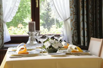 a table with a white table cloth and wine glasses at Kasteel van Nieuwland in Aarschot