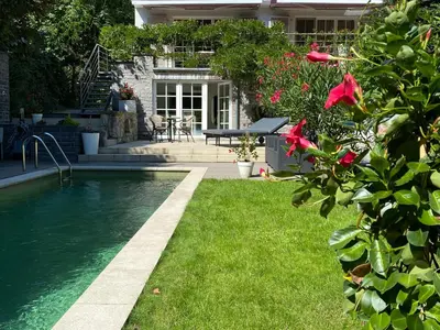 a house with a swimming pool in the yard at Studio swimming pool BXL in Dilbeek
