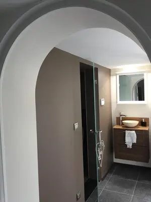 a bathroom with a sink and a glass shower at Studio swimming pool BXL in Dilbeek