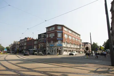 a city street with a building on the side of the road at Hotel Bristol Internationaal in Mortsel