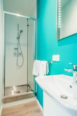 a bathroom with a glass shower and a sink at Ooostel2.be Leuven in Leuven