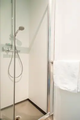 a shower with a glass door in a bathroom at Ooostel2.be Leuven in Leuven