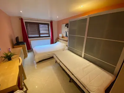 a small bedroom with a bed and a window at Residence la Fraisiere in Brussels