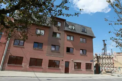 a large red brick building on a city street at Residence la Fraisiere in Brussels