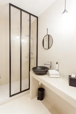 a bathroom with a sink and a shower at Latroupe Hotel Jardin Secret in Brussels