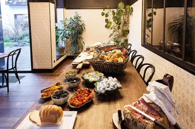 a table with many different types of food on it at Latroupe Hotel Jardin Secret in Brussels