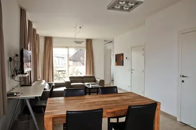 a living room with a table and chairs at Place 2 stay in Ghent