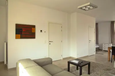 a living room with a couch and a table at Place 2 stay in Ghent