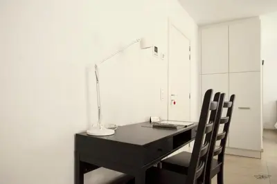 a desk with a lamp and a laptop on it at Place 2 stay in Ghent