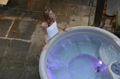 a young girl standing next to a tub of water at Trumpet House in Leuven
