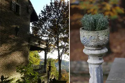 a stone planter with a plant in it next to a building at Trumpet House in Leuven