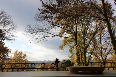 a park bench in front of a fence at Trumpet House in Leuven
