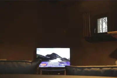 a television screen in a living room with a couch at Trumpet House in Leuven