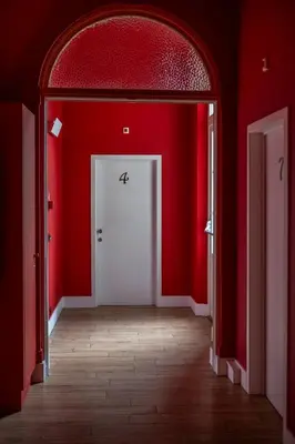an empty room with red walls and a white door at Hotel Onderbergen in Ghent
