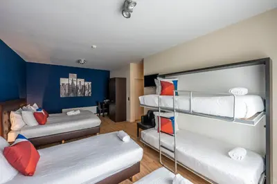a room with three bunk beds and a couch at Hotel Onderbergen in Ghent