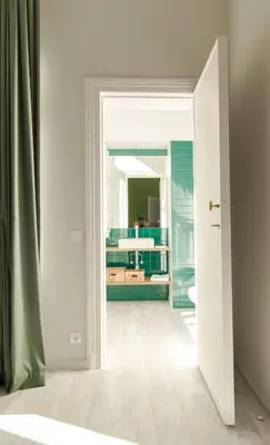 an open door to a bathroom with a mirror at Wok Rooms in Brussels