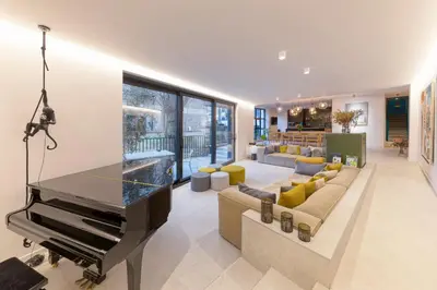a living room with a piano and a couch at Wok Rooms in Brussels