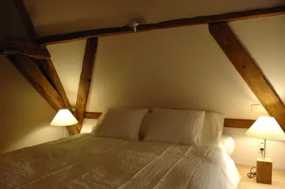 a bedroom with a large bed with two lamps at De Waterzooi Suites in Ghent