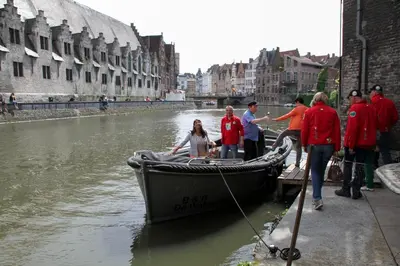 a group of people on a boat in a canal at De Waterzooi Suites in Ghent