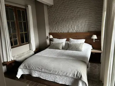 a bedroom with a large bed and a window at De Waterzooi Suites in Ghent